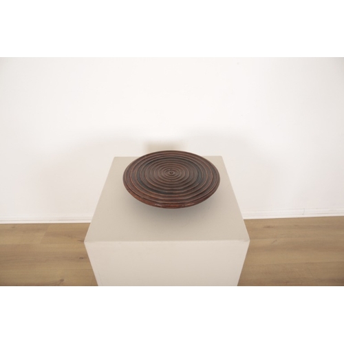 215 - A MAHOGANY LAZY SUSAN

19th century, with concentric carved circles and on flared circular turned ba... 