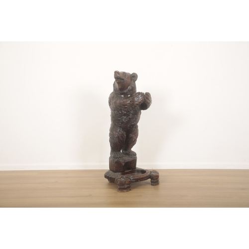 225 - A BLACK FOREST CARVED BEAR STICK OR UMBRELLA STAND

late 19th/early 20th century, with glass eyes an... 