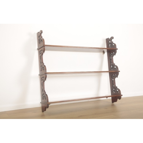 235 - A MAHOGANY THREE TIER WALL SHELF OF GEORGIAN STYLE

with pierced sides, 92cm high x 107cm wide x 19.... 