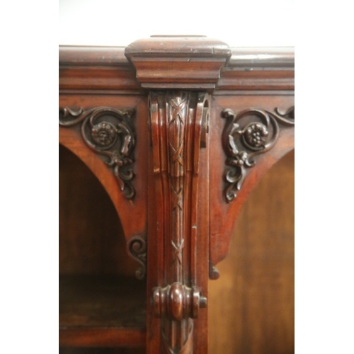 252 - A VICTORIAN MAHOGANY OPEN FRONT BOOKCASE

the top with moulded edge, above arched frieze and four re... 