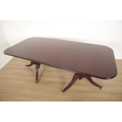 253 - A MAHOGANY TWIN PEDESTAL DINING TABLE

the top with moulded edge and fitted one extra leaf, on splay... 