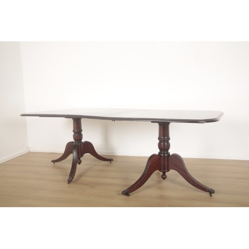 253 - A MAHOGANY TWIN PEDESTAL DINING TABLE

the top with moulded edge and fitted one extra leaf, on splay... 