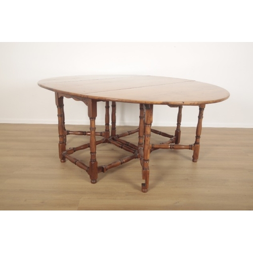 268 - A YEW WOOD OVAL GATELEG TABLE

of 18th century style, on slender turned legs, 75cm high x 152cm long... 