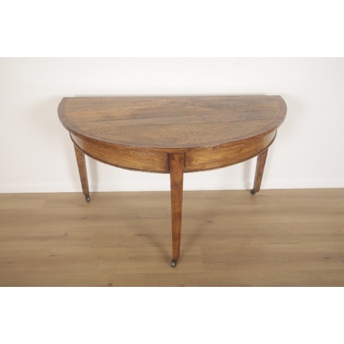 279 - AN ELM, OAK AND BURR WOOD DEMI-LUNE TABLE

early 19th century, three tapering legs terminating on la... 