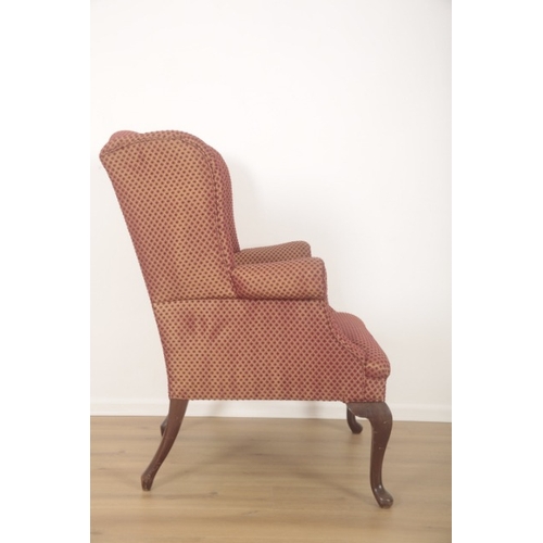 285 - A  WING ARMCHAIR IN GEORGIAN STYLE

late 20th century, the mahogany cabriole legs terminating on pad... 