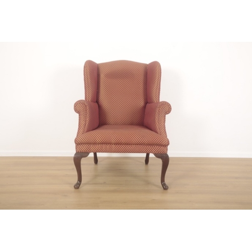 285 - A  WING ARMCHAIR IN GEORGIAN STYLE

late 20th century, the mahogany cabriole legs terminating on pad... 