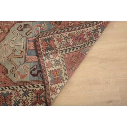 348 - A BELUCH RUG OF KAZAK STYLE

woven in orange, brown, madder and other colours with two lozenge medal... 