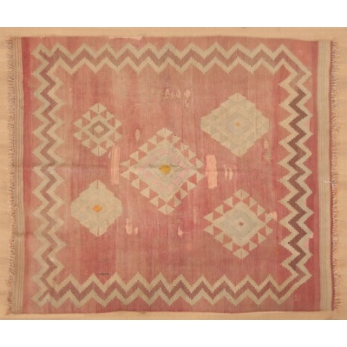 352 - A KAZAK SOUMAKH

woven in colours with geometric motifs on a madder ground, within conforming border... 