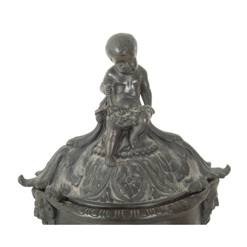 97 - A BRONZE URN AND COVER

early 19th century, with seated cherub finial, the body with twin satyr hand... 