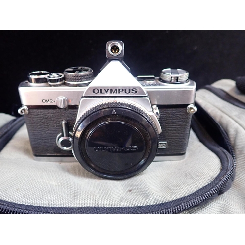 118 - AN OLYMPUS OM2 35MM SLR CAMERA with three lenses and accessories, contained in camera bag, together ... 