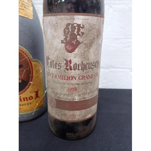 140 - COTES ROCHEUSES SAINT-EMILION GRAND CRU 1978 a 75cl bottle, no. 843441 together with a bottle of Fau... 