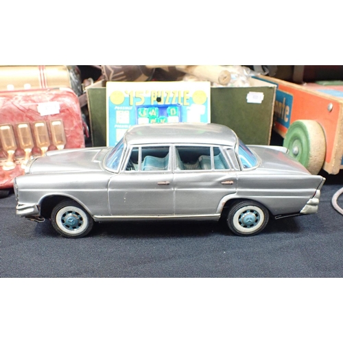 202 - A COLLECTION OF VINTAGE TOYS including a Japanese 'Benz 220' tinplate car, a Hong Kong '15' puzzle o... 