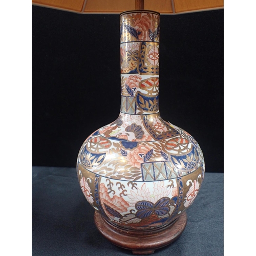 230 - AN IMARI STYLE BOTTLE VASE LAMP heavily painted and gilt 32cm high plus fittings and stand