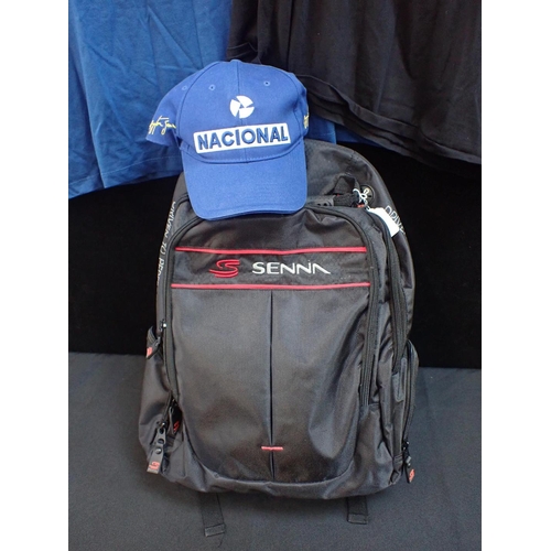 237 - AN AYRTON SENNA RUCKSACK red embroidery on black, containing a Nacional baseball cap and two Ayrton ... 