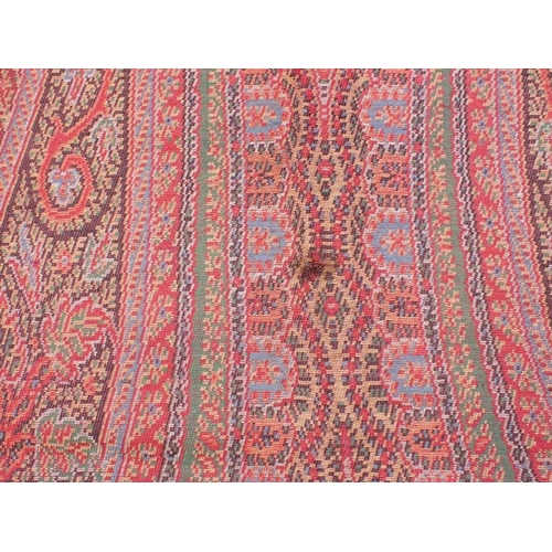 284 - AN ANTIQUE WOOLLEN PAISLEY 'CRINOLINE' SHAWL with fringe, approx 330 x 167cm (some marks, but appear... 