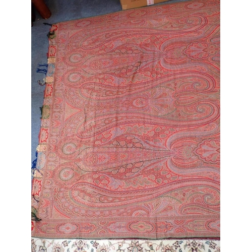 284 - AN ANTIQUE WOOLLEN PAISLEY 'CRINOLINE' SHAWL with fringe, approx 330 x 167cm (some marks, but appear... 