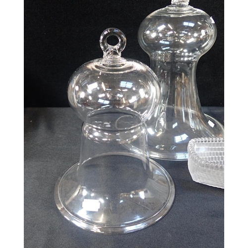 293 - TWO GLASS SMOKE BELLS OR CLOCHES 30cm and 24cm high, a glass candle lamp (drilled base), a heavy rib... 