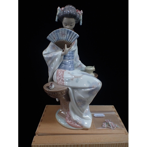 301 - A LLADRO PORCELAIN FIGURE OF A SEATED JAPANESE LADY holding a fan, 24cm high, with a box (flowers da... 