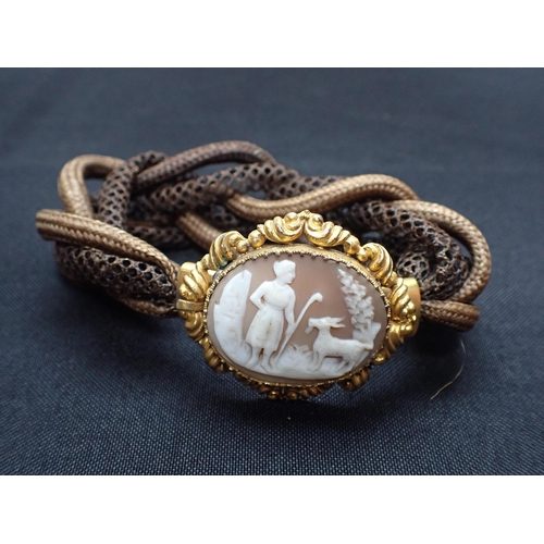 426 - A VICTORIAN CAMEO AND WOVEN HAIR BRACELET with gilded mount