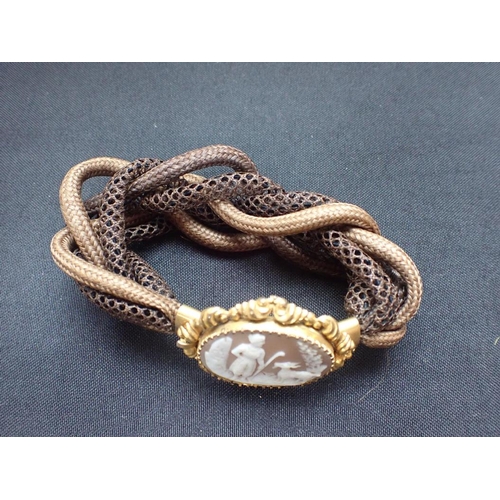 426 - A VICTORIAN CAMEO AND WOVEN HAIR BRACELET with gilded mount