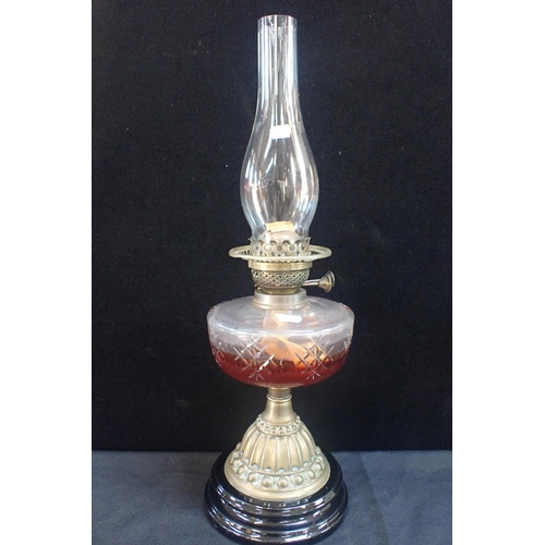 54 - A VICTORIAN OIL LAMP with brass and ceramic base with (a/f) chimney, two other (non fitting) lamp ch... 