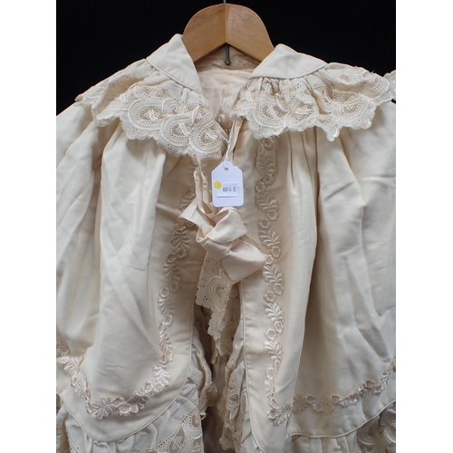 64 - AN EDWARDIAN CHILDS' CAPE with lace trim and ribbon fastening (ribbon a/f)