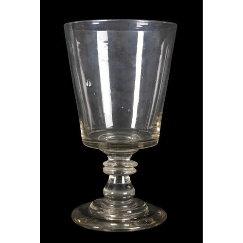 101 - A CLEAR GLASS OVERSIZED GOBLET

early 19th century, with tapered bowl on double ring stem and circul... 