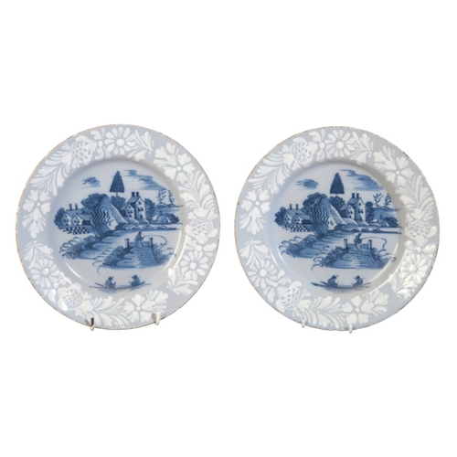 2 - A PAIR OF DELFT LILAC GLAZED PLATES

18th century, painted in blue with a river landscape depicting ... 