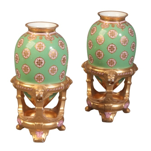 57 - A PAIR OF MINTON BONE CHINA VASES

19th century, modelled as ovoid urns supported by gilded stands, ... 