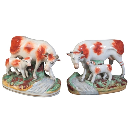 86 - AN OPPOSING PAIR OF STAFFORDSHIRE COWS WITH CALVES

19th century, figured naturistically on a plinth... 