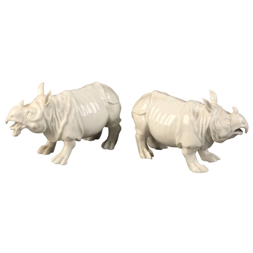 95 - A PAIR OF MEISSEN PORCELAIN RHINOCEROS

19th century, bearing blue crossed swords marks to the bases... 