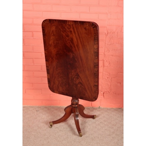 111 - A GEORGE IV MAHOGANY AND ROSEWOOD CROSSBANDED OCCASIONAL TABLE

the rectangular tilting top on a tur... 