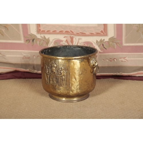 119 - A VICTORIAN BRASS LOG BIN

of circular section with ring handles, the body embossed with an armorial... 