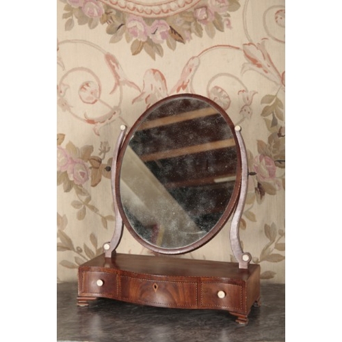 121 - A REGENCY MAHOGANY DRESSING MIRROR

the oval plate above a base with the short drawers, on ogee brac... 