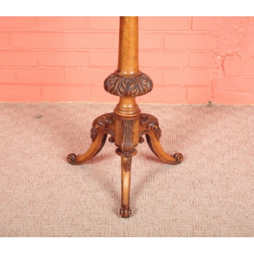 124 - A VICTORIAN WALNUT AND MARQUETRY TRIPOD TABLE

the shaped top inlaid with a central floral spray, on... 