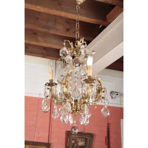 129 - A VICTORIAN STYLE CUT GLASS AND GILT METAL CHANDELIER

with four floral decorated branches with cut ... 