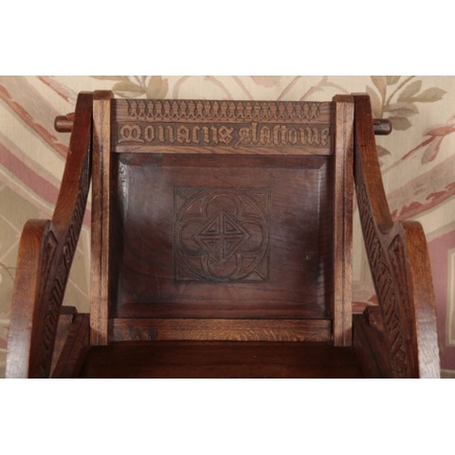 130 - AN OAK 'GLASTONBURY' ARMCHAIR

early 20th century, with carved decoration and lettering, 86cm high x... 