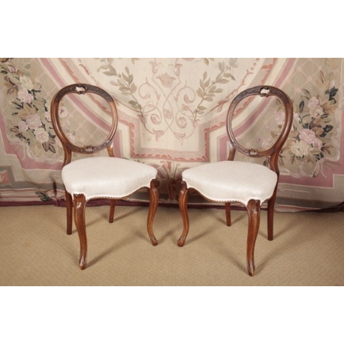 157 - A PAIR OF VICTORIAN WALNUT BALLOON-BACK SIDE CHAIRS

with carved and pierced cresting rail over cove... 