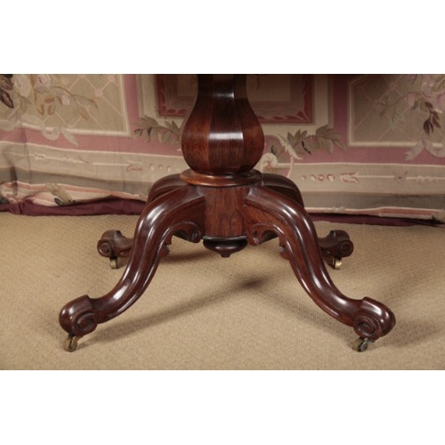 163 - A VICTORIAN ROSEWOOD CENTRE TABLE

the shaped tilt-top on a faceted baluster stem, to a quadruped ba... 