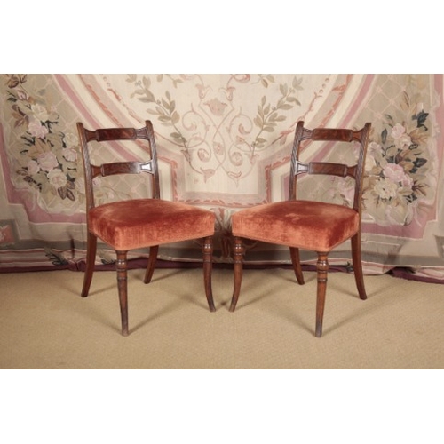 164 - A SET OF FOUR REGENCY MAHOGANY DINING CHAIRS

the shaped bar backs over velvet covered seats, on rin... 