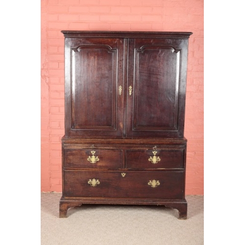 174 - A GEORGE III OAK LINEN PRESS

the upper section with a moulded cornice over panelled cupboards openi... 