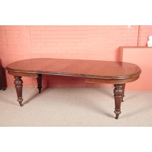 182 - A VICTORIAN MAHOGANY WIND-OUT EXTENDING DINING TABLE

with spare leaf, on turned legs ending in bras... 