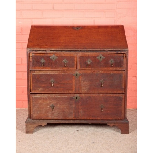 196 - AN OAK BUREAU

early 18th century, the fall front opening to a fitted interior with green baize-line... 