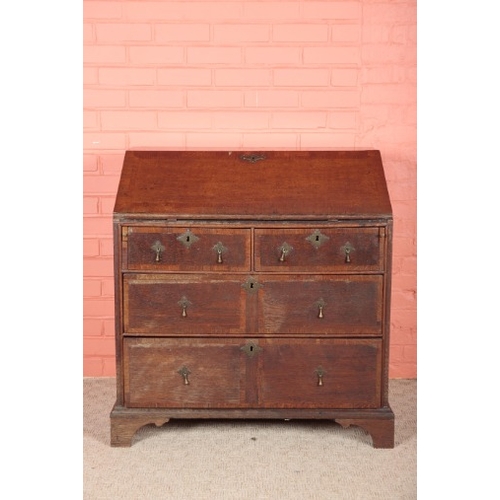 196 - AN OAK BUREAU

early 18th century, the fall front opening to a fitted interior with green baize-line... 