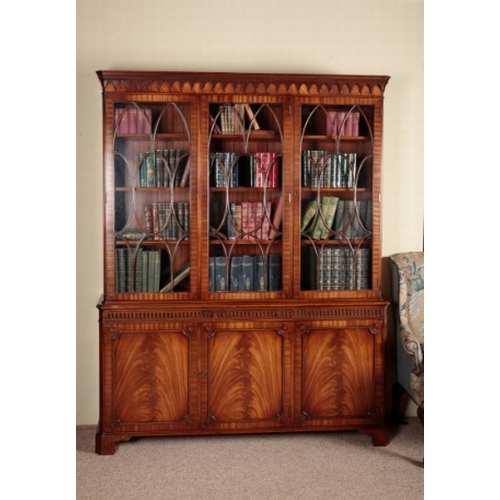 213 - A GEORGE III STYLE MAHOGANY BOOKCASE

the upper section with moulded cornice over astragal glazed do... 