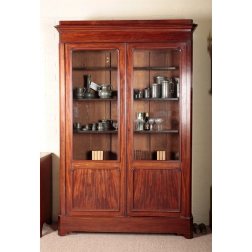 216 - A VICTORIAN MAHOGANY BOOKCASE

the moulded cornice over glazed and panelled cupboard doors opening t... 