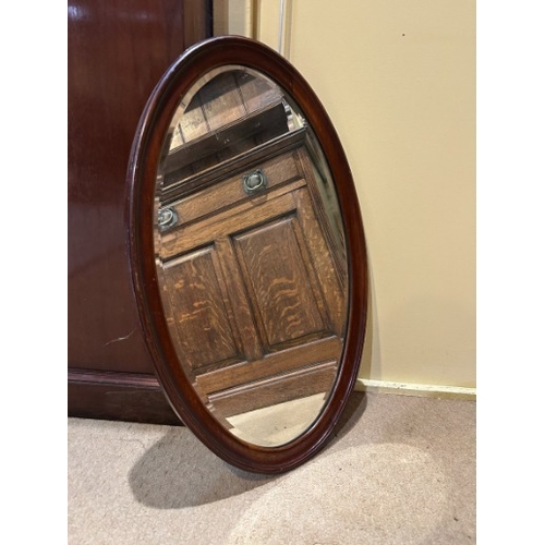 228 - A GILTWOOD MIRROR

late 19th/early 20th century, the oval bevelled plate within an 