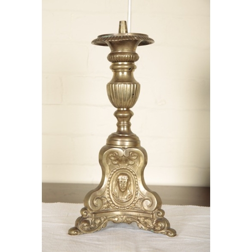 236 - A PAIR OF CONTINENTAL BRASS PRICKET CANDLESTICKS

19th century, on triform bases embossed with masks... 