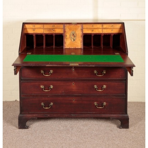 245 - A GEORGE III MAHOGANY BUREAU

the fall front opening to an interior fitted with a baize writing surf... 