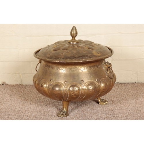 257 - A BRASS LIDDED STAND

19th century, with a lifting metal insert, two ring handles issuing from lions... 